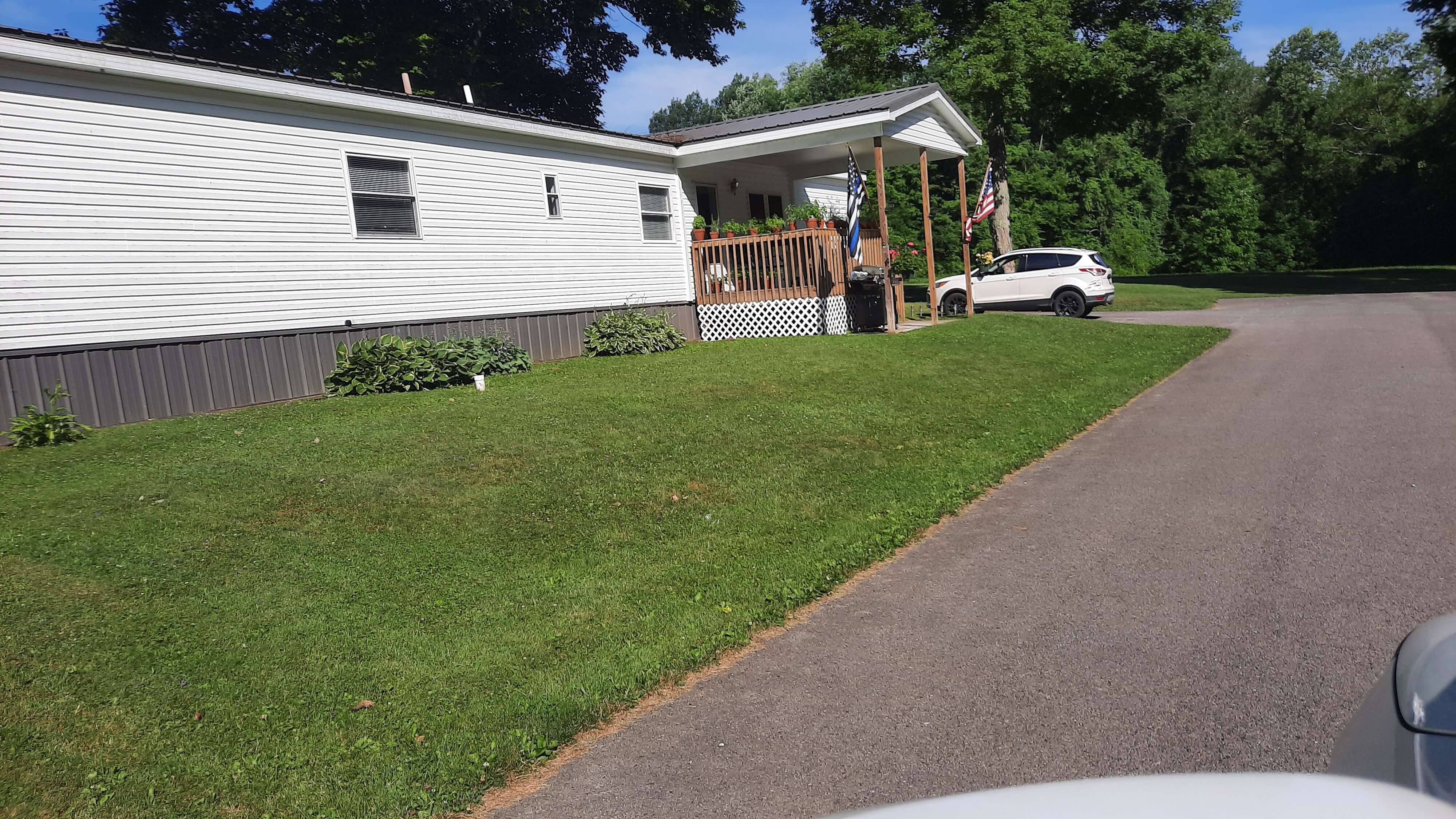 Open yard and porch of mobile home