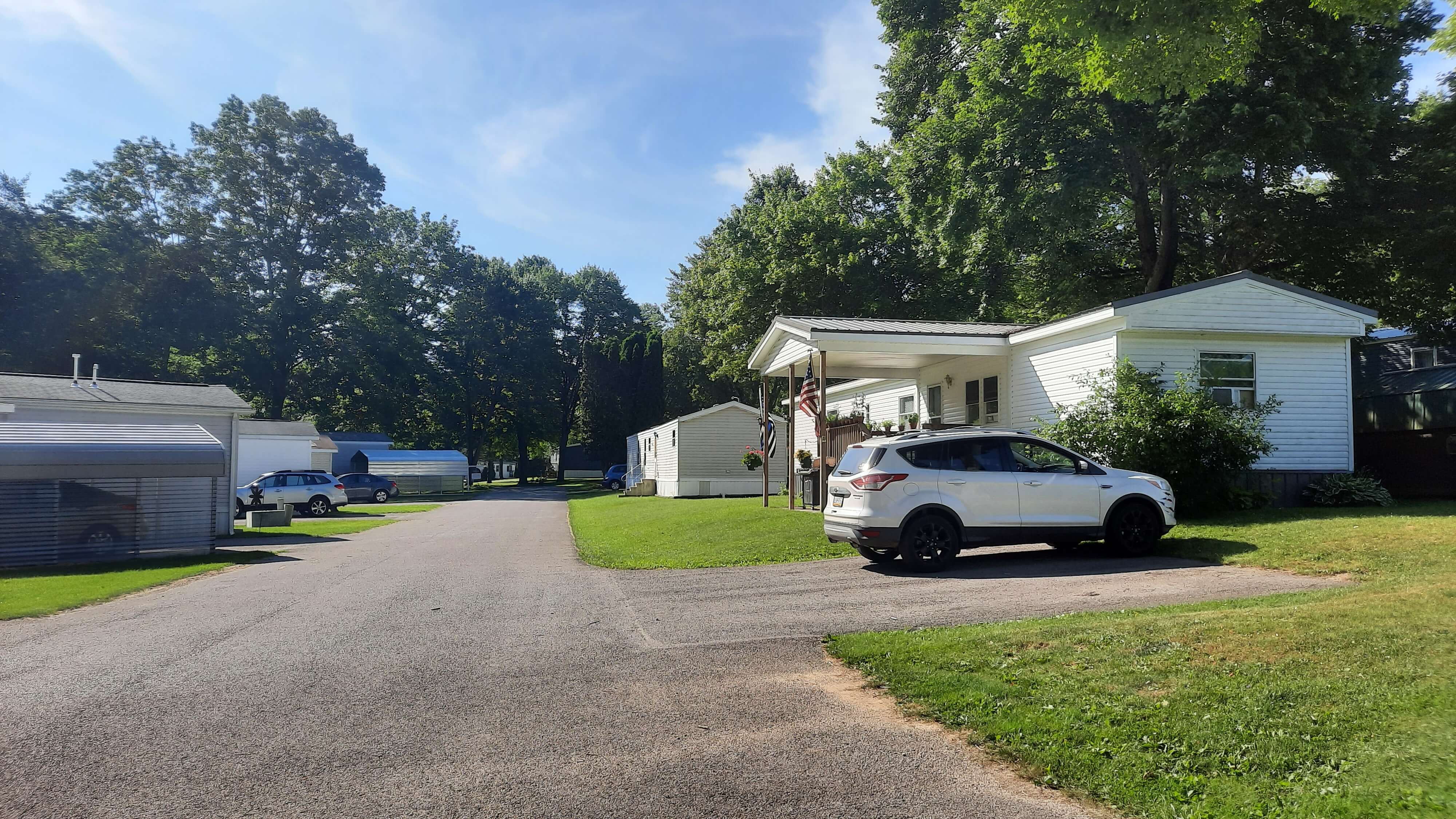 Community road with covered parking spaces and driveways